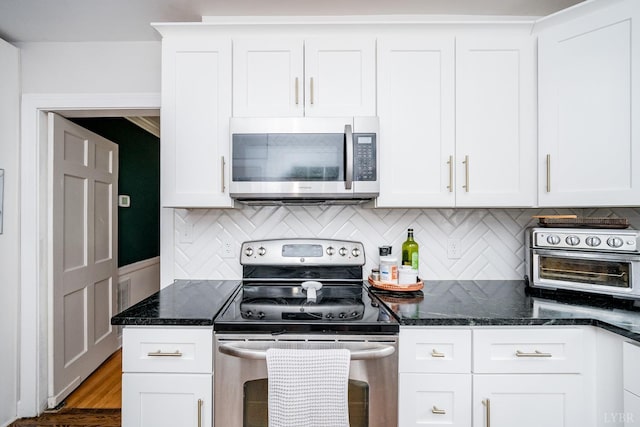 213 Kensington Ave, Lynchburg, VA 24503 - kitchen with appliances with stainless steel finishes, tasteful backsplash, white cabinetry, and dark stone countertops