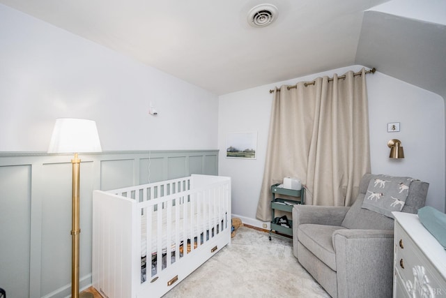 213 Kensington Ave, Lynchburg, VA 24503 - bedroom with lofted ceiling, a crib, and a wainscoted wall