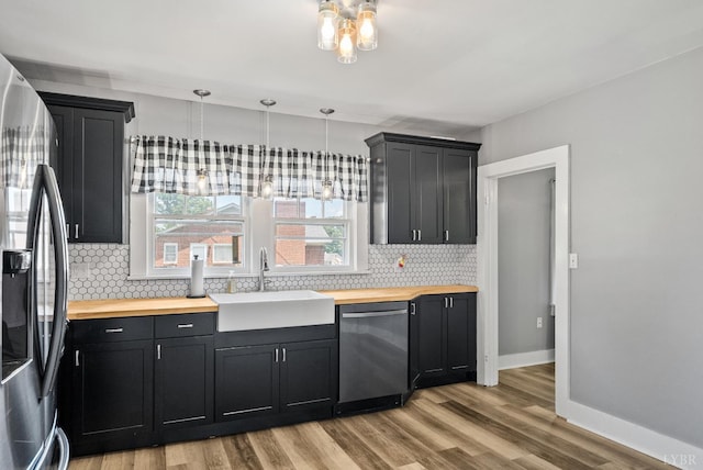 200 Jasper Wood Rd, Hurt, VA 24563 - kitchen with stainless steel appliances, a sink, wood counters, and decorative backsplash
