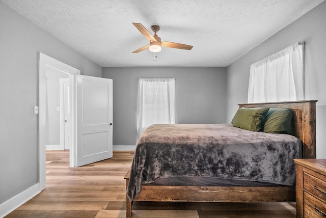 200 Jasper Wood Rd, Hurt, VA 24563 - bedroom featuring light wood-style flooring, baseboards, a textured ceiling, and a ceiling fan