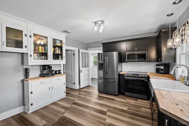 200 Jasper Wood Rd, Hurt, VA 24563 - kitchen featuring butcher block countertops, appliances with stainless steel finishes, decorative backsplash, and a sink