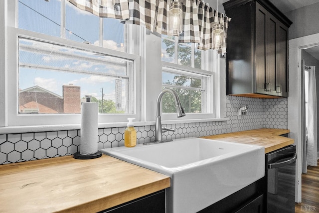 200 Jasper Wood Rd, Hurt, VA 24563 - kitchen featuring wood counters, a sink, dishwashing machine, tasteful backsplash, and dark cabinetry
