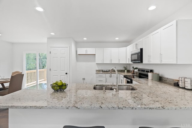 1040 Coronado Ln, Lynchburg, VA 24502 - kitchen featuring stainless steel electric stove, a sink, light stone countertops, recessed lighting, and white cabinets