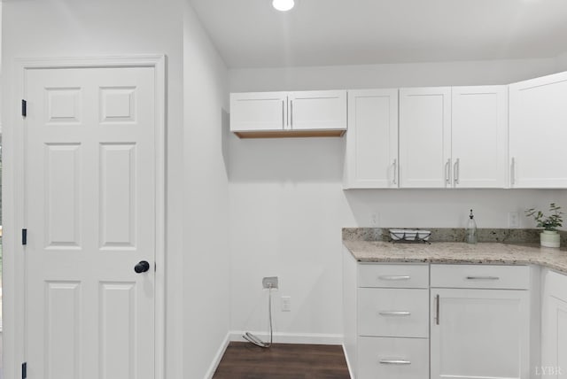 1040 Coronado Ln, Lynchburg, VA 24502 - kitchen with white cabinets, baseboards, light stone countertops, and dark wood-type flooring