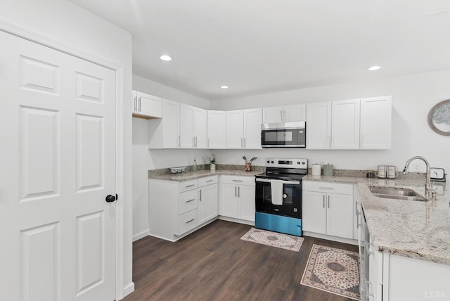 1040 Coronado Ln, Lynchburg, VA 24502 - kitchen featuring electric range, stainless steel microwave, a sink, dark wood finished floors, and light stone counters