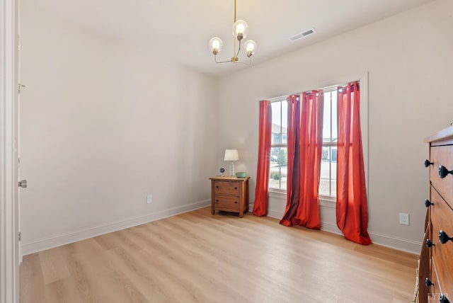 1268 Stoney Ridge Blvd, Forest, VA 24551 - unfurnished room with light wood-style flooring, a chandelier, and baseboards