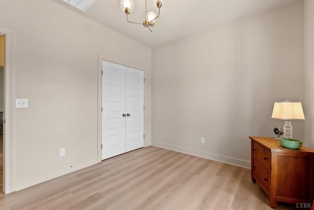 1268 Stoney Ridge Blvd, Forest, VA 24551 - unfurnished bedroom featuring light wood-style flooring, a chandelier, baseboards, and a closet