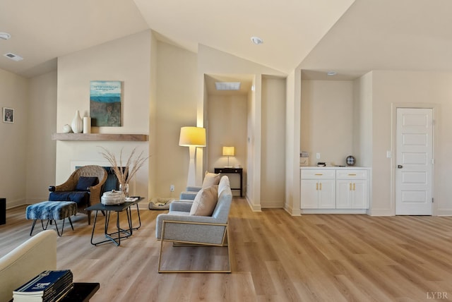 1268 Stoney Ridge Blvd, Forest, VA 24551 - living area featuring light wood-style floors, vaulted ceiling, baseboards, and a fireplace