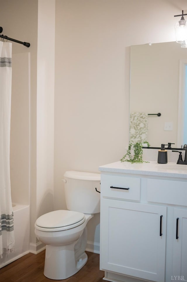 128 Brenleigh Ct Unit 105, Lynchburg, VA 24501 - bathroom with vanity, wood finished floors, toilet, shower / bathtub combination with curtain, and baseboards