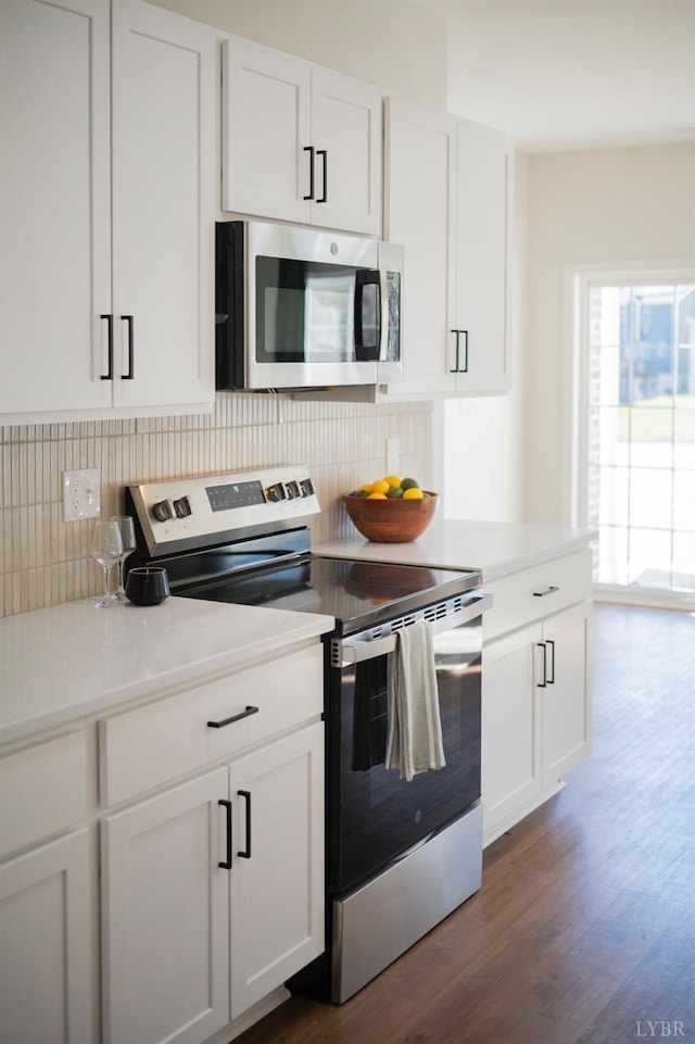 128 Brenleigh Ct Unit 105, Lynchburg, VA 24501 - kitchen with stainless steel appliances, dark wood-style flooring, tasteful backsplash, and white cabinets