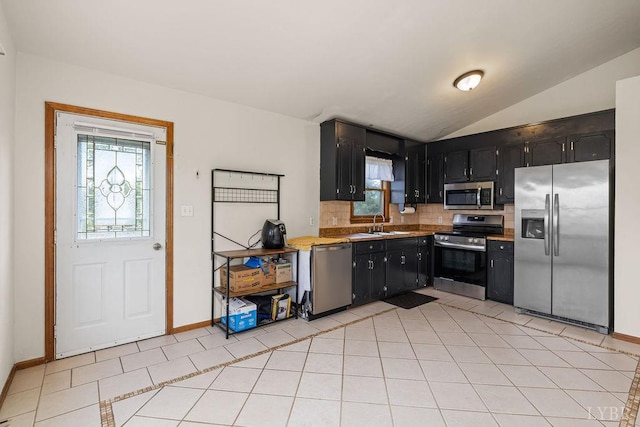 115 Mattiponi Dr, Madison Heights, VA 24572 - kitchen featuring stainless steel appliances, decorative backsplash, dark cabinets, plenty of natural light, and vaulted ceiling