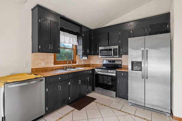 115 Mattiponi Dr, Madison Heights, VA 24572 - kitchen featuring stainless steel appliances, a sink, dark cabinetry, lofted ceiling, and tasteful backsplash