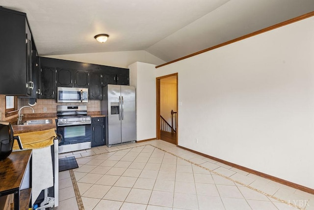 115 Mattiponi Dr, Madison Heights, VA 24572 - kitchen with stainless steel appliances, lofted ceiling, dark cabinetry, light tile patterned floors, and a sink