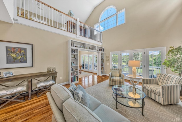 145 Golfers Crossing Dr, Penhook, VA 24137 - living room with french doors, wood finished floors, a towering ceiling, and baseboards