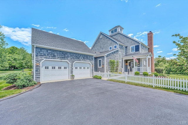145 Golfers Crossing Dr, Penhook, VA 24137 - shingle-style home featuring asphalt driveway, a chimney, a garage, a fenced front yard, and covered porch