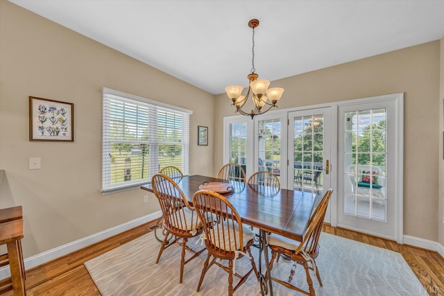 145 Golfers Crossing Dr, Penhook, VA 24137 - dining area featuring a chandelier, baseboards, and light wood finished floors