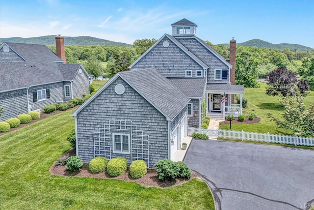 145 Golfers Crossing Dr, Penhook, VA 24137 - view of front facade with covered porch, driveway, a chimney, and a mountain view