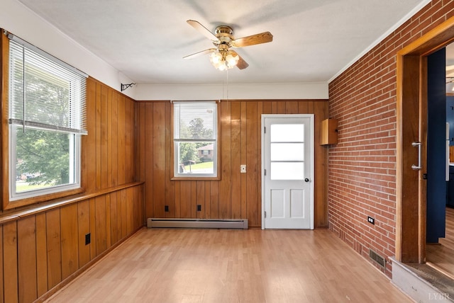 147 Maple Dr, Madison Heights, VA 24572 - empty room featuring light wood-type flooring, a baseboard radiator, healthy amount of natural light, brick wall, and a ceiling fan