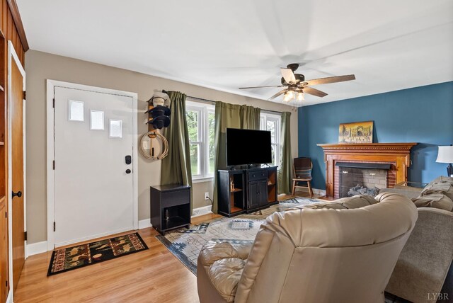147 Maple Dr, Madison Heights, VA 24572 - living area with a ceiling fan, light wood-style floors, a brick fireplace, and baseboards