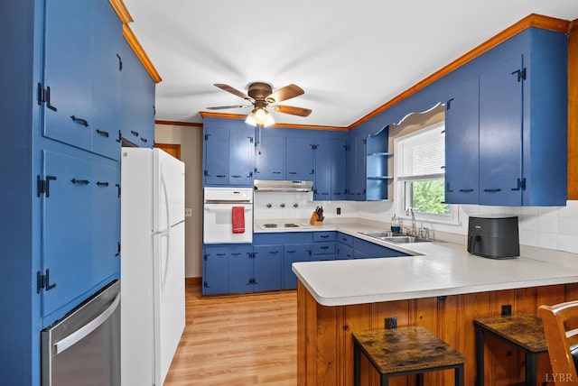 147 Maple Dr, Madison Heights, VA 24572 - kitchen featuring white appliances, blue cabinetry, a sink, a peninsula, and under cabinet range hood
