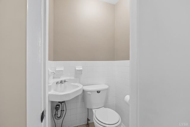 147 Maple Dr, Madison Heights, VA 24572 - half bath with toilet, a wainscoted wall, a sink, and tile walls