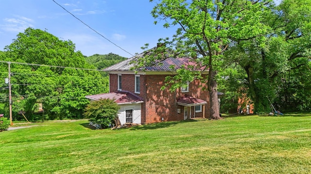 10662 Lee Jackson Hwy, Big Island, VA 24526 - view of side of home featuring brick siding, a yard, and metal roof