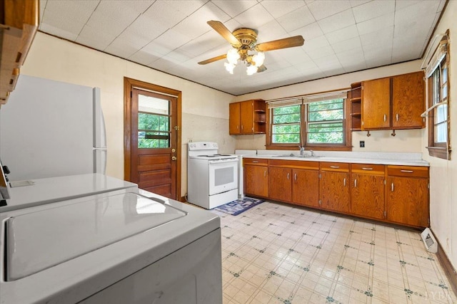 1104 Amherst Ave, Altavista, VA 24517 - kitchen featuring white appliances, open shelves, light floors, brown cabinets, and ceiling fan