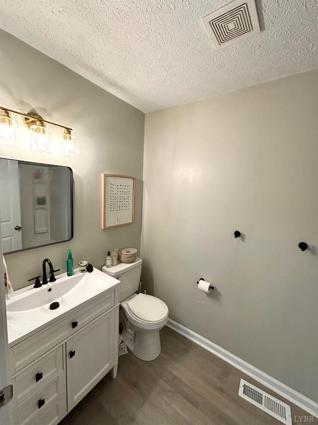 136 Jubilee Dr, Lynchburg, VA 24501 - bathroom with wood finished floors, vanity, a textured ceiling, toilet, and baseboards