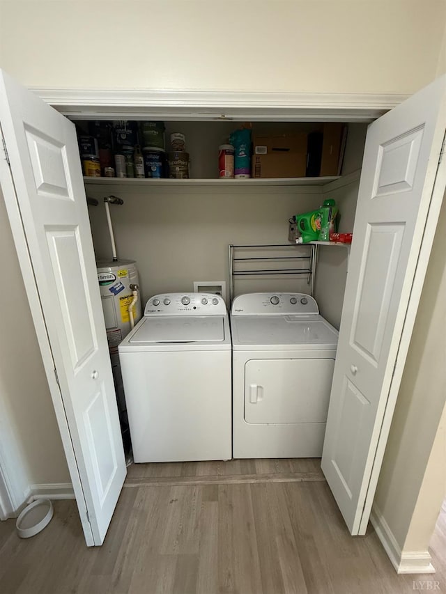 136 Jubilee Dr, Lynchburg, VA 24501 - laundry area with washing machine and clothes dryer, light wood-style flooring, water heater, and baseboards