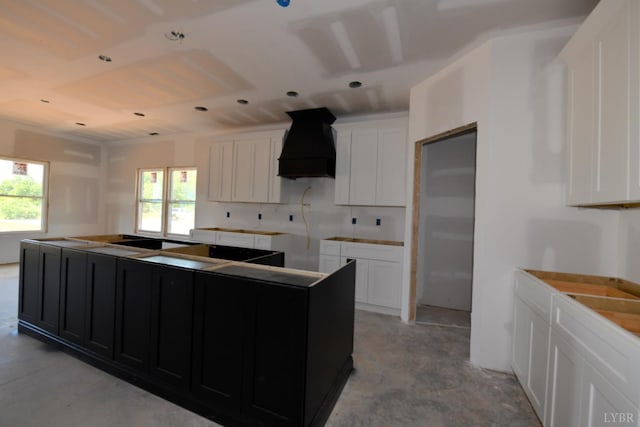 24 Stony Ridge Blvd, Forest, VA 24551 - kitchen with custom exhaust hood, healthy amount of natural light, a center island, and dark cabinets