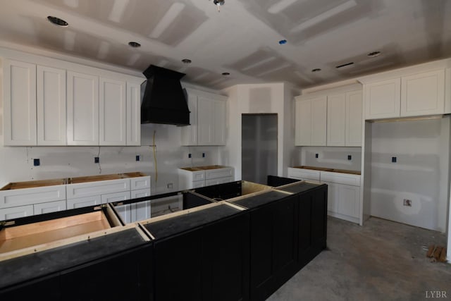 24 Stony Ridge Blvd, Forest, VA 24551 - kitchen featuring custom range hood, concrete flooring, and white cabinets