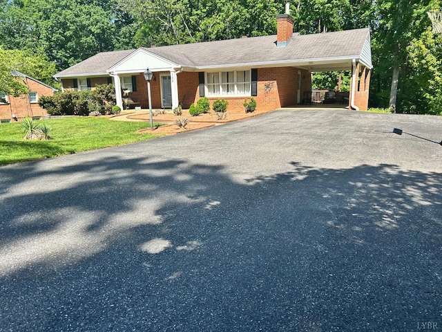 155 Arrowhead Dr, Lynchburg, VA 24502 - view of front of home featuring brick siding, driveway, a chimney, a front lawn, and an attached carport