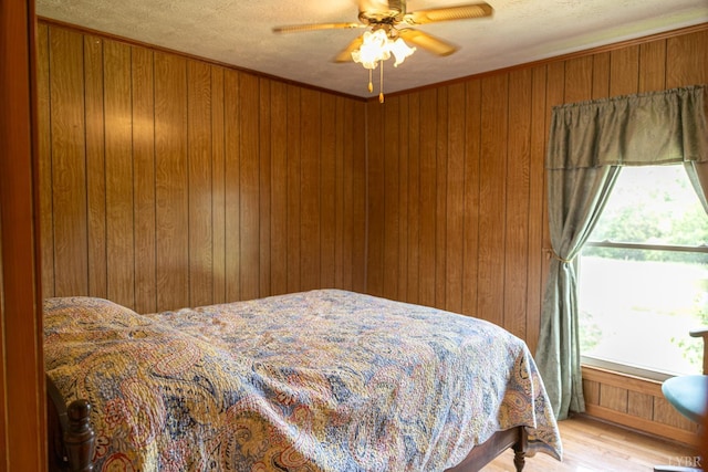 20586 Kings Hwy, Randolph, VA 23962 - bedroom featuring wooden walls, a textured ceiling, wood finished floors, and ceiling fan