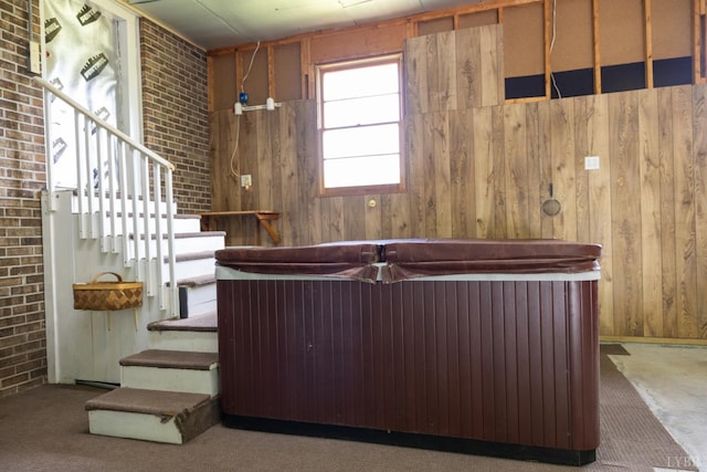 20586 Kings Hwy, Randolph, VA 23962 - miscellaneous room with carpet floors, wood walls, stairs, and brick wall