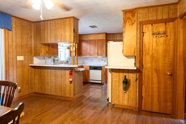 20586 Kings Hwy, Randolph, VA 23962 - kitchen featuring dishwasher, brown cabinetry, light countertops, a peninsula, and a ceiling fan
