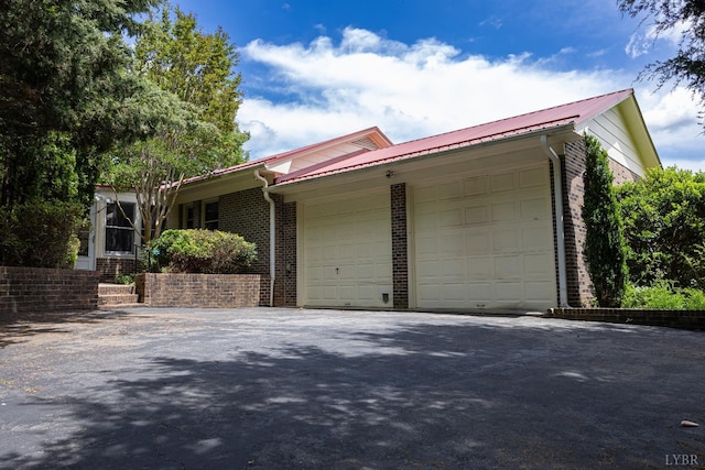 20586 Kings Hwy, Randolph, VA 23962 - view of front of property featuring brick siding, a garage, metal roof, and driveway
