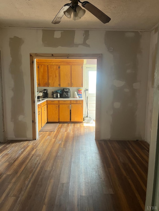 1115 Jackson St, Lynchburg, VA 24504 - kitchen featuring light countertops, hardwood / wood-style flooring, ceiling fan, a textured ceiling, and brown cabinets