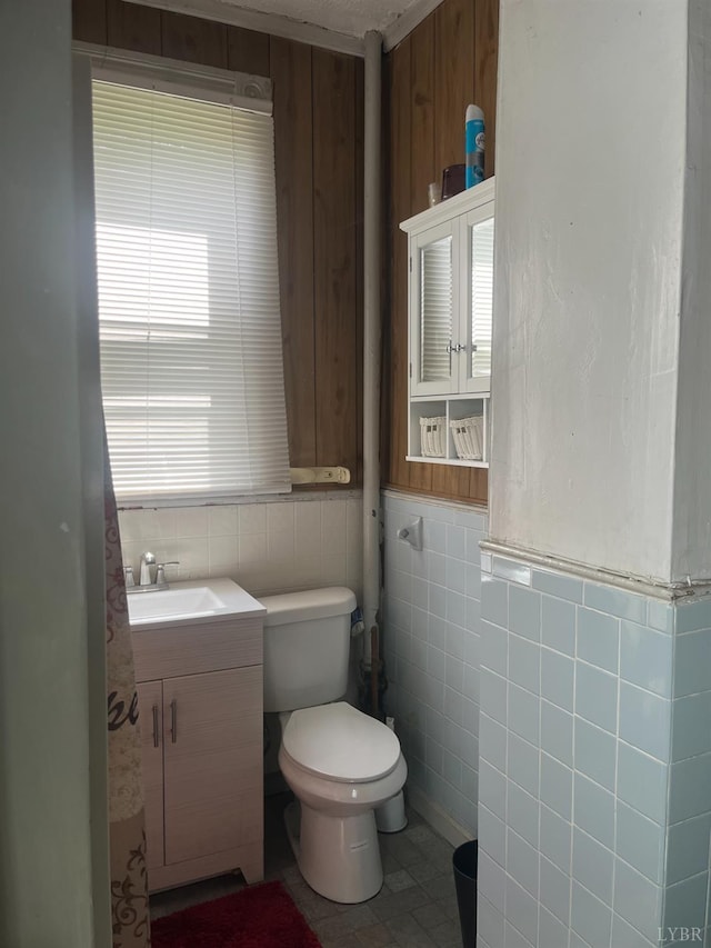 1115 Jackson St, Lynchburg, VA 24504 - half bathroom with tile walls, toilet, vanity, and wainscoting