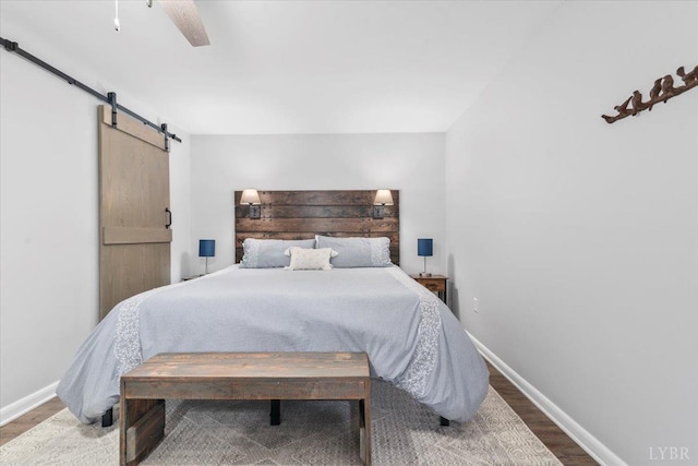 261 Carrington Ln, Roseland, VA 22967 - bedroom featuring a barn door, wood finished floors, baseboards, and ceiling fan