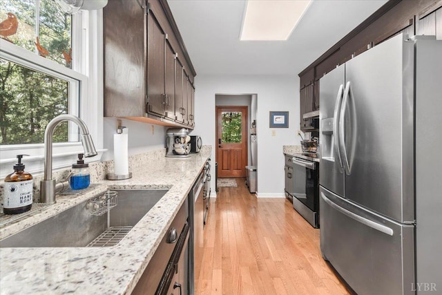 261 Carrington Ln, Roseland, VA 22967 - kitchen with appliances with stainless steel finishes, a sink, dark brown cabinetry, and light wood finished floors