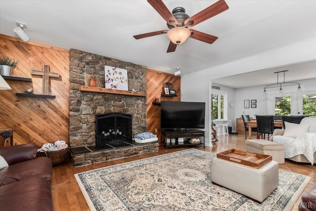 261 Carrington Ln, Roseland, VA 22967 - living room featuring a ceiling fan, wood walls, a fireplace, and wood finished floors
