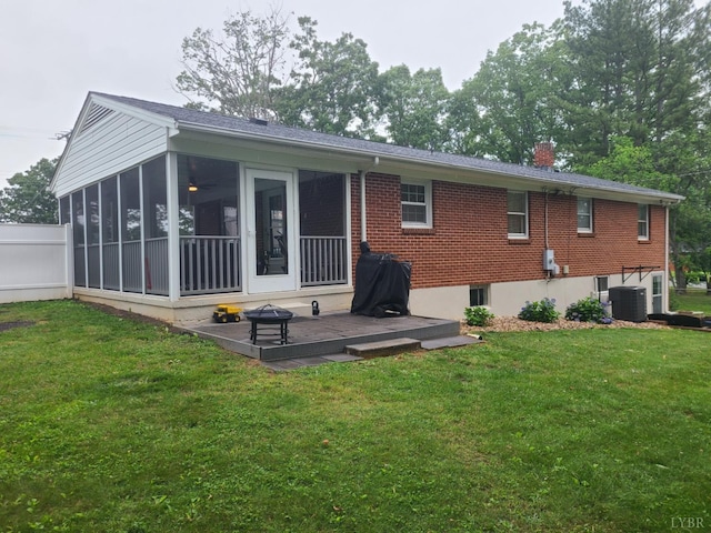 356 Ferguson St, Appomattox, VA 24522 - back of house featuring central AC unit, a lawn, a sunroom, and a chimney