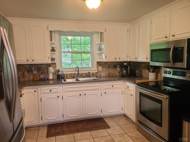 356 Ferguson St, Appomattox, VA 24522 - kitchen with appliances with stainless steel finishes, open shelves, a sink, dark countertops, and white cabinets