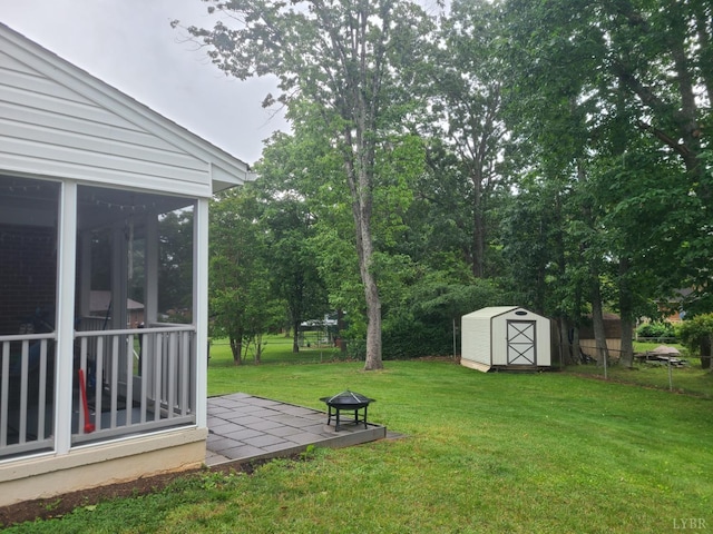 356 Ferguson St, Appomattox, VA 24522 - view of grassy yard featuring a sunroom, a patio, and a fire pit