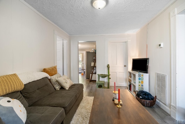 400 Blue Ridge St, Lynchburg, VA 24501 - living area featuring wood finished floors, ornamental molding, a textured ceiling, and a decorative wall