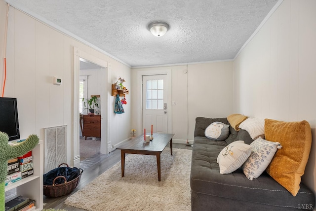 400 Blue Ridge St, Lynchburg, VA 24501 - living room with crown molding, wood finished floors, a textured ceiling, baseboards, and a decorative wall