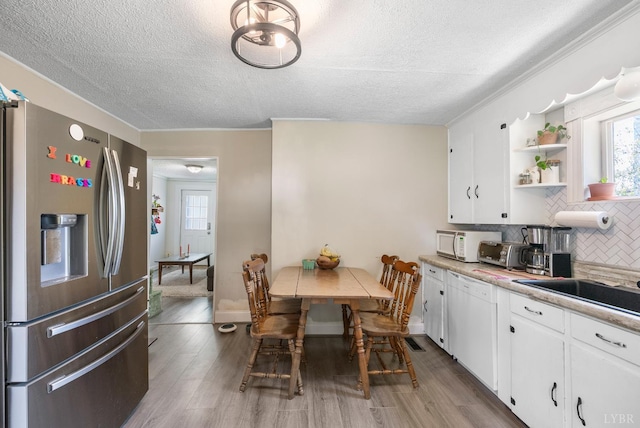 400 Blue Ridge St, Lynchburg, VA 24501 - kitchen with white appliances, a textured ceiling, tasteful backsplash, open shelves, and white cabinetry