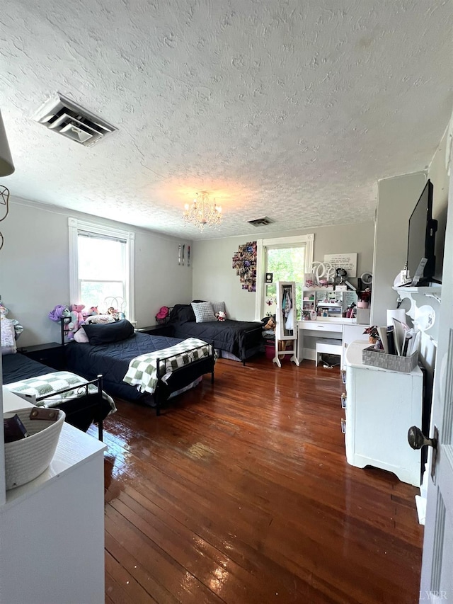 221 Castle Craig Dr, Evington, VA 24550 - bedroom featuring a textured ceiling, hardwood / wood-style flooring, and a chandelier