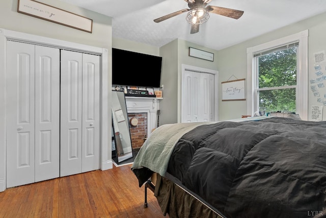 221 Castle Craig Dr, Evington, VA 24550 - bedroom with multiple closets, wood finished floors, and a ceiling fan