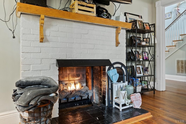 221 Castle Craig Dr, Evington, VA 24550 - detailed view of a brick fireplace, baseboards, and wood finished floors